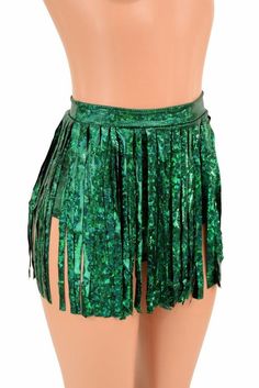 a woman's green skirt with fringes on the bottom and side, in front of a mannequin torso