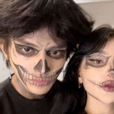 two people with face paint on their faces