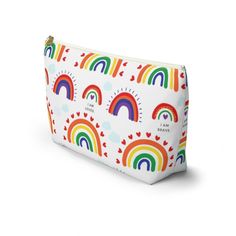 a white bag with rainbows and hearts on the front, it has a zipper closure