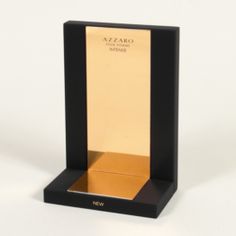 a black and gold award is in a wooden box on a white surface with the word azzaro written across it