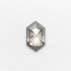 a diamond is shown on a white surface