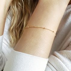 "We love the elegant look and lightweight feel of our 14k gold filled satellite bracelet. Alone or stacked, this dainty gold chain bracelet is the perfect everyday bracelet. Available in 14k gold filled, sterling silver and rose gold filled. SIZING GUIDE * 6\" (XXS/XS) * 6.5\" (Small) * 7\" (Medium) * 7.5\" (Large/XL) Please see our photos to learn how to measure the perfect length. CRAFTSMANSHIP  Jewelry is handmade by us in our NYC studio. We focus on craftsmanship and quality using only the highest quality materials and handpicked genuine gemstones.  PACKAGING We take pride in creating beautifully packaged orders. Jewelry arrives delicately wrapped in tissue and placed in a kraft box inside a logo drawstring pouch. Your package will arrive nice enough to gift someone.  If you need your Dainty Everyday Chain Bracelet, Dainty Beaded Bracelets With Adjustable Chain, Dainty Satellite Chain Bracelet For Everyday, Dainty 14k Gold Beaded Bracelets, Dainty 14k Gold Filled Bracelet, Delicate Gold Bracelet With Satellite Chain For Everyday, Dainty Chain Bracelet With Simple Design For Everyday, Delicate Beaded Bracelets With Satellite Chain, Minimalist Gold Bracelet With Satellite Chain