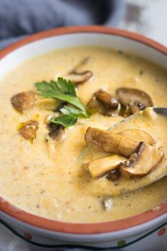 a close up of a bowl of soup with mushrooms