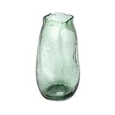 a green glass vase sitting on top of a white table