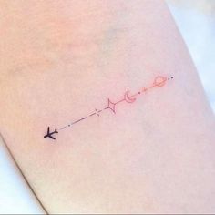 an airplane is flying through the sky with a line tattoo on its side ribcage