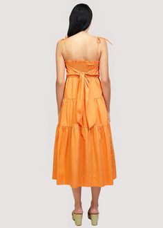 Get ready to turn heads in our Paradiso Midi Dress! Made from soft cotton poplin in a beautiful apricot shade, this dress is a true sun dress silhouette. Its relaxed fit and easy midi length make it the perfect choice for sunny days. Complete your look with sandals and a sun hat. WDWH23282 Imported Lined Self: 100% CottonLining: 100% Rayon Model is 5 ft 9.5 inches; Bust: 32", Waist: 24", Hips: 34" and wearing a size Small Runs true to size Hand wash or wash with gentle cycle with cold water with Solid Cotton Midi Dress For Beach, Cotton Midi Sundress For Brunch, Cotton Midi Dress For Summer, Solid Color Summer Midi Dress For Daywear, Orange Cotton Midi Dress For Beach, Orange Cotton Midi Dress For Vacation, Solid Summer Midi Dress, Solid Midi Sundress For Brunch, Orange Midi Dress For Beach