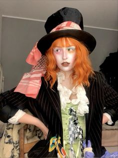 a woman with red hair wearing a top hat