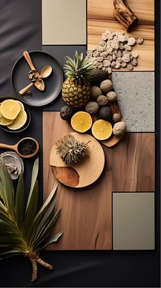 the table is set with pineapples, lemons, and other fruits on it