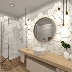 a bathroom with hexagonal tiles on the wall and wooden countertop, along with a round mirror