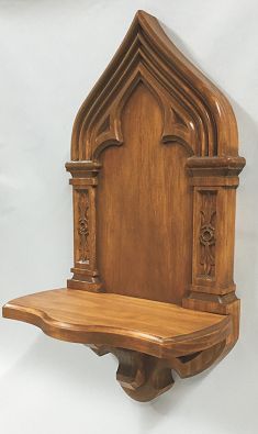 an ornate wooden shelf with carved carvings on the top and bottom, against a white background