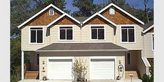 two story house with three car garages in front