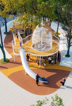 an artist's rendering of a playground in the middle of a tree - lined park