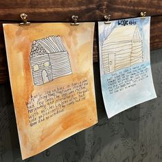 three children's drawings hanging on the wall with clothes pins attached to them and some writing