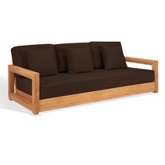 a wooden couch with brown pillows on it's back and arm rests against a white background