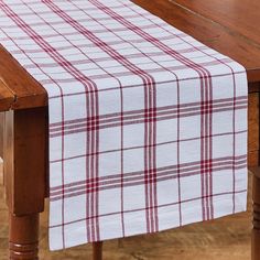 a red and white checkered table runner on a wooden table