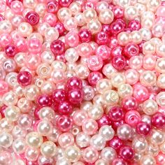 pink and white pearls are scattered together