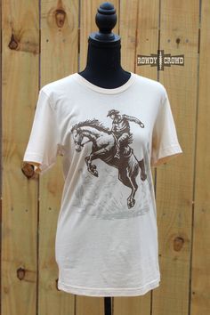 Unleash your inner cowboy/cowgirl with our Bronc Buster Tee! This cute and authentic rodeo-inspired shirt is true to size, providing a comfortable and stylish fit for all. Show off your love for the wild west with every wear. Yeehaw! 52% Cotton, 48% Polyester The Wild West, Cowboy Cowgirl, Cowboy And Cowgirl, Plus Size Shopping, Blankets For Sale, Country Girl, Wholesale Clothing, Wild West, Rodeo