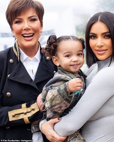 kim kardash and her daughter are smiling for the camera