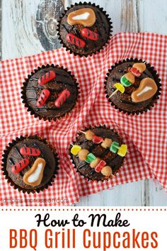 four cupcakes decorated with candy and candies on a red checkered cloth