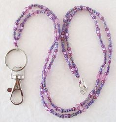 Lavender Purple Beaded Lanyard This Lavender Purple Beaded Lanyard can be used as a badge holder, an I.D. holder, or keychain necklace - it's a multi-use accessory for home or office! 32" in length, long enough to put on or remove overhead. It also has an easy-to-use lobster clasp for your convenience. It's made with purple glass beads and strong C-Lon beading cord. Snap-on badge holder, clip, and keyring are included to keep your badges or keys ready when you need them. This Lavender Purple Bea Adjustable Purple Badge Holders As Gift, Keychain Necklace, Beading Cord, Beaded Lanyards, Id Badge Holders, Purple Glass, Id Badge, Badge Holders, Handmade Accessories