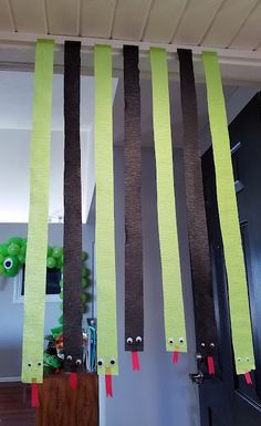 the door is decorated with strips of paper and tape to make it look like trees