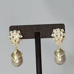 These Beautiful Bridal Earrings Will Complete Your Look On Your Special Day. They Feature The Timeless Elegance Of A Teardrop Champagne Pearl Encrusted With Simulated Diamonds Set In Champagne Gold Hanging From A Beautiful Cluster Of Simulated Diamonds At The Top. The Post Is Made Of Pure 925 Sterling Silver. Glamorous Formal Clip-on Bridal Earrings, Elegant Formal Clip-on Crystal Earrings, Elegant Jeweled Teardrop Dangle Earrings, Elegant Jeweled Clip-on Earrings For Formal Occasions, Elegant Jeweled Clip-on Earrings For Formal Events, Formal Jeweled Drop Clip-on Earrings, Silver Pear Bridal Earrings For Evening, Silver Clip-on Teardrop Earrings For Formal Occasions, Formal Teardrop Crystal Clip-on Earrings