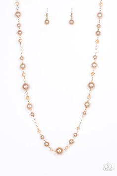 Varying in size, glittery crystal-like beads and pearly golden beads trickle along a shimmery gold chain for a refined look. Features an adjustable clasp closure. Sold as one individual necklace. Includes one pair of matching earrings. Glamorous Gold Pearl Necklace, Gold-tone Beaded Party Jewelry, Pearl Beaded Necklaces With Chain For Party, Pearl Beaded Necklace With Chain For Parties, Gold Beaded Pearl Necklace For Formal Occasions, Party Pearl Beaded Chain Necklace, Party Gold-tone Necklace With Gold Beads, Glamorous Gold Beaded Necklaces, Gold Pearl Necklace With Adjustable Chain For Party