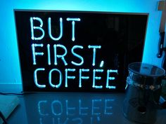 a neon sign that says but first, coffee