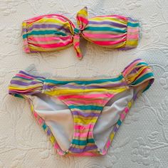 Victoria’s Secret - Striped Bikini Set - Two Piece Soft Bikini Set (Spandex Waterproof Material) - Hard To Find Rare Style! - Size: Small (True To Size For Both) - Strapless Bandeau Style Top With Tie Bow, Tie Included - Bottom Is Small Cheeky Style - Stickers Removed With Intention To Wear But Never Worn - Like New Condition, Never Worn Or Used Yellow Strapless Swimwear For Poolside, Yellow Strapless Swimwear For Beach Party, Multicolor Strapless Stretch Swimwear, Yellow Strapless Beachwear Swimwear, Yellow Fitted Beachy Tankini, Yellow Strapless Swimwear For Summer, Beachy Yellow Bandeau Swimwear, Victoria's Secret Multicolor Swimwear For Sunbathing, Victoria's Secret Yellow Swimwear For Vacation