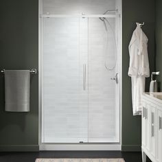 a bathroom with a walk in shower next to a sink