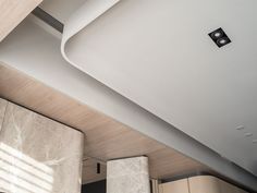 the interior of a modern home with wood and white decor on the walls, ceiling and bed