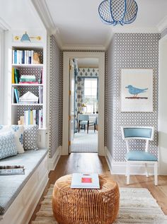 a living room filled with lots of furniture and bookshelves next to a doorway