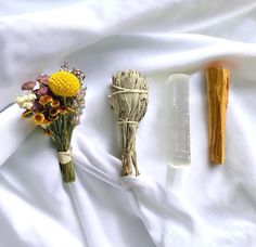 three different types of flowers on a white sheet