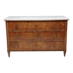 an old wooden dresser with marble top