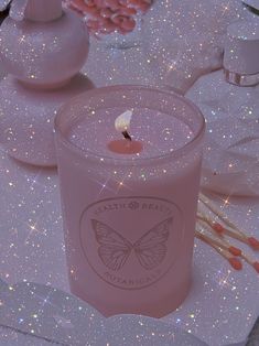 a pink candle sitting on top of a table