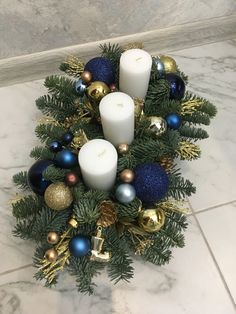 some candles are sitting in a wreath on the floor