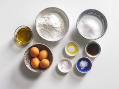 several bowls with eggs and flour in them