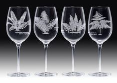 three wine glasses with etched leaves on them