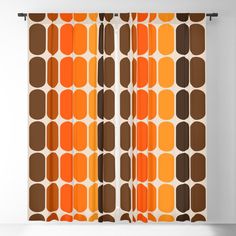 an orange and brown curtain with circles on it