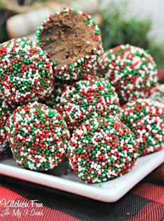 a plate full of christmas sprinkle covered cookies