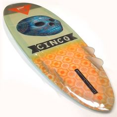 an orange and blue surfboard with the word cinco on it