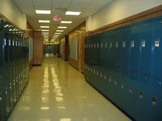 an empty hallway with lockers and the words propensity to discuss