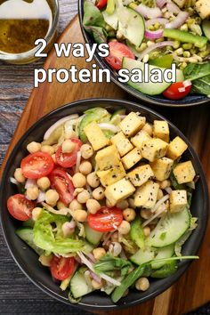 two bowls filled with salad on top of a wooden cutting board next to a bowl of dressing