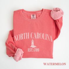 This North Carolina vintage sweatshirt is the perfect item to remember your east coast trip or moving gift for your friends and family. Luxurious comfort and style are what this unisex, garment-dyed sweatshirt is all about. It's made with 80% ring-spun cotton and 20% polyester and the fabric is 3-end garment-dyed, ring-spun, color-blast fleece with a 100% cotton face. Each sweatshirt comes with a relaxed fit, a rolled-forward shoulder, and a back neck patch. .: 80% ring-spun cotton, 20% polyeste Casual Crew Neck T-shirt With Lettering, Cotton Crew Neck T-shirt With Lettering, Relaxed Fit Crew T-shirt With Lettering, Casual Pink Crew Neck T-shirt, Casual Pink Crew T-shirt, North Carolina Embroidery, Newport Sweatshirt, Souvenir Sweatshirt, Beach Crewneck