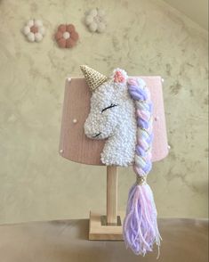 a lamp that has a stuffed unicorn on it