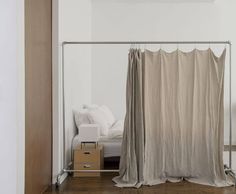 a room with a bed and a curtain in it