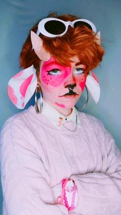 a woman with red hair and makeup has her face painted like a dog wearing sunglasses