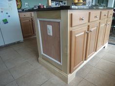 a kitchen island made out of plywood and wood with an icebox on top