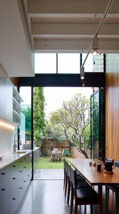 an open kitchen and dining room area with sliding glass doors leading to the back yard