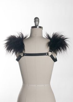 This chest harness with faux fur shoulder detail adds instant gothic drama and impact to any outfit. This piece works especially well with dresses and flowing tops that don't have a defined waistline, or paired with a corset. Buckles in front across chest. Silver toned nickel-plated steel hardware. Shown in black leather. Also available in PVC. All colors have black faux fur except white PVC, which has white faux fur.All pieces are MADE TO ORDER, standard sizes XS-4XL. If your measurements fall Shoulder Harness, Chest Harness, Black Pvc, Black Vegan, White Faux Fur, Black Faux Fur, Large Black, Custom Fit, Leather Handmade